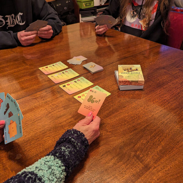 Family playing an 86 it! card