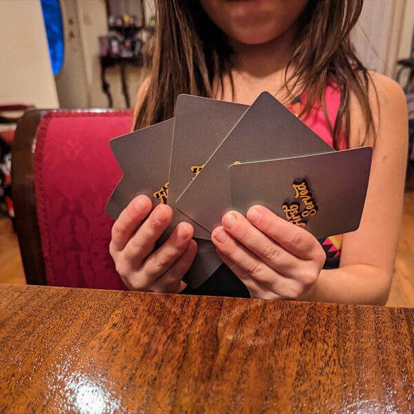 Child holding a hand of cards